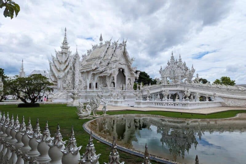 Das prachtvoll geschmückte, weiße Hauptgebäude des Wat Rong Khun in Chiang Rai